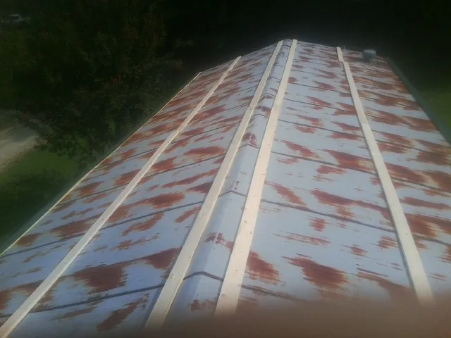 Rusted metal roof panels with new wood purlins before replacement — Storm Damage Roof Repair in Milner by Roofing Brothers